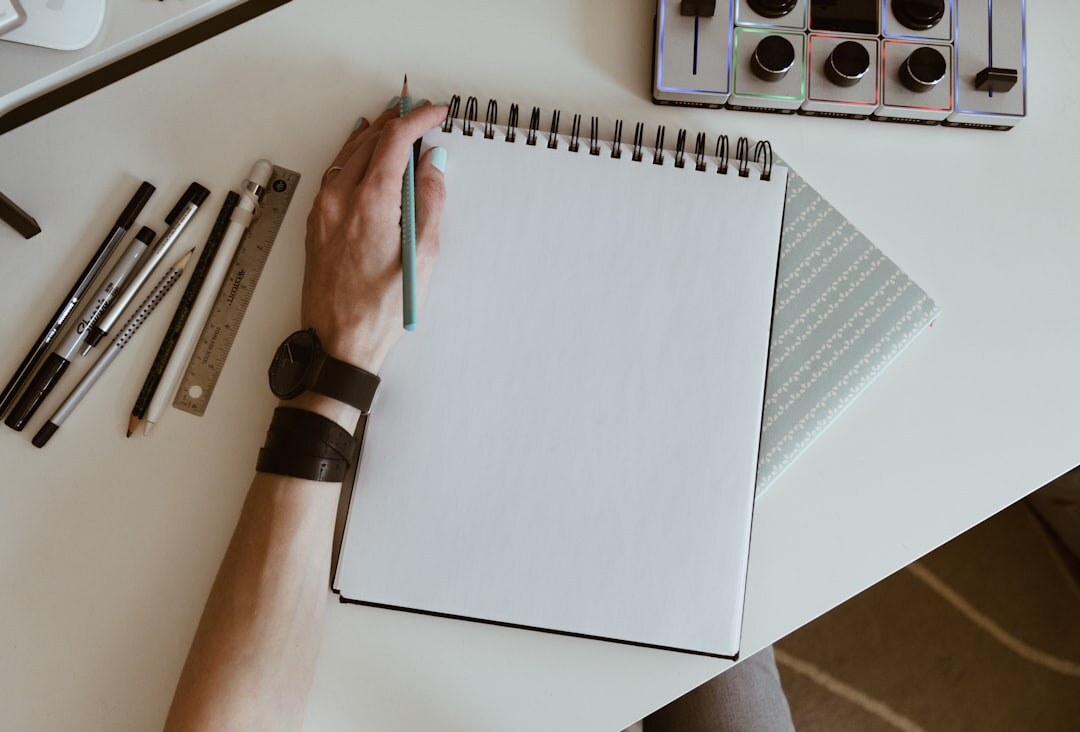 person writing in notebook