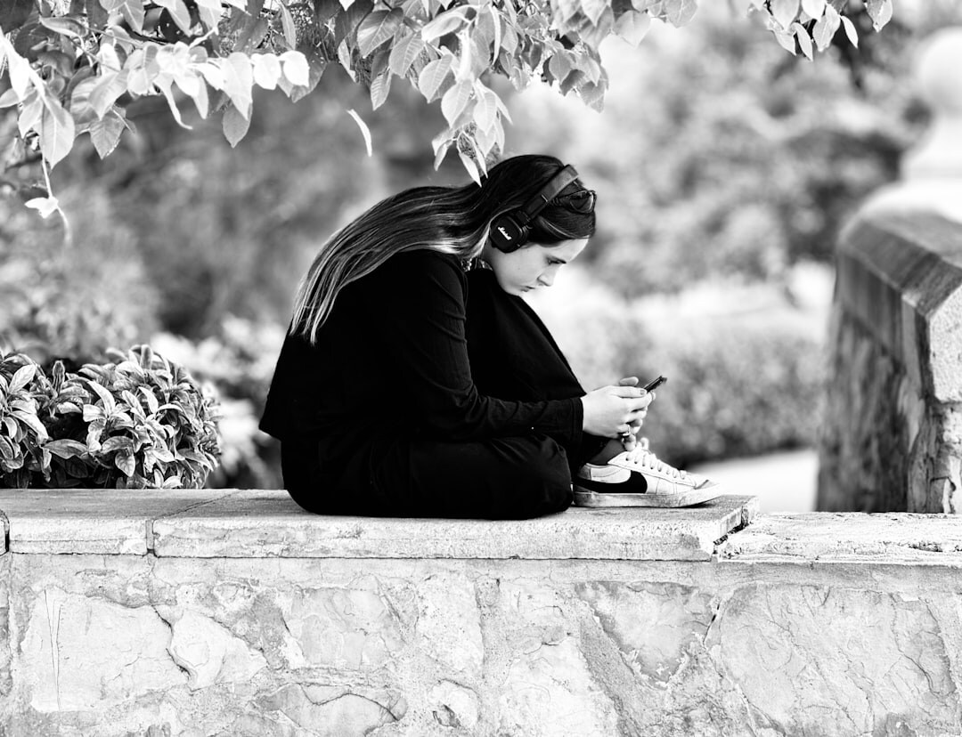 woman writing in journal outdoors